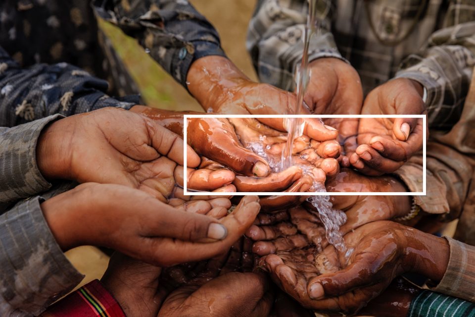 Fresh water pouring over children's hands